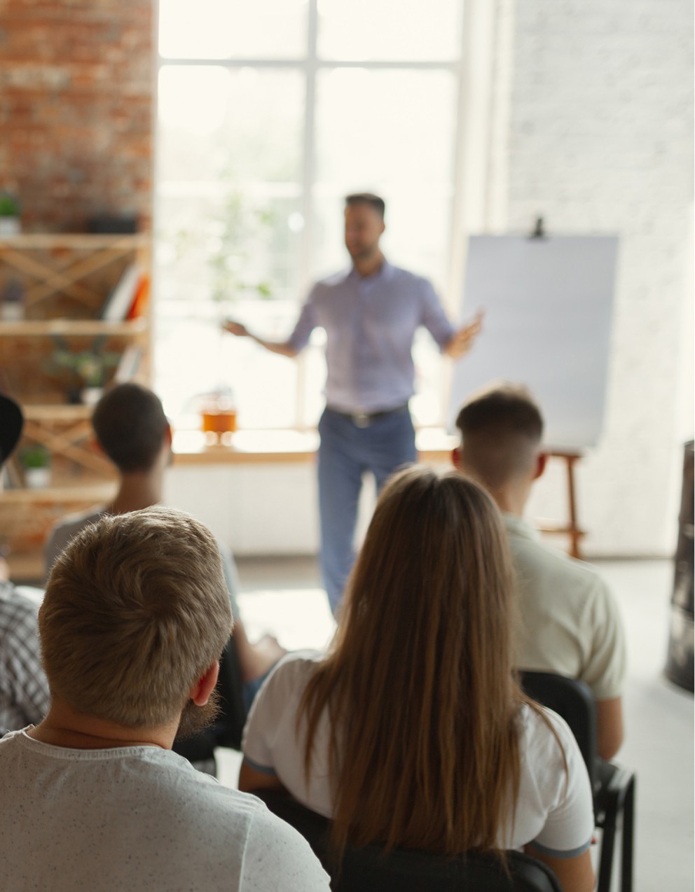 person making a presentation to a group of people